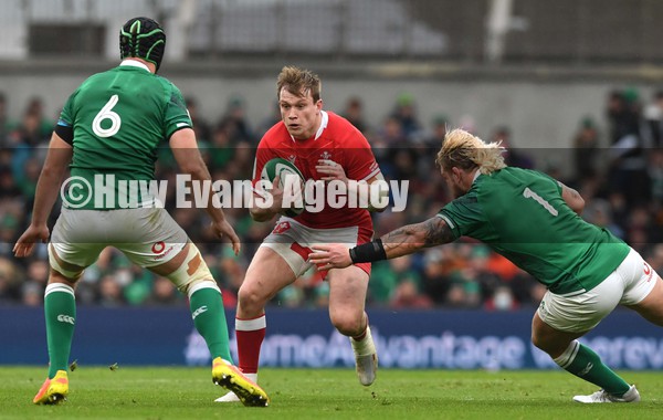 050222 - Ireland v Wales - Guinness Six Nations - Nick Tompkins of Wales takes on Caelan Doris and Andrew Porter of Ireland