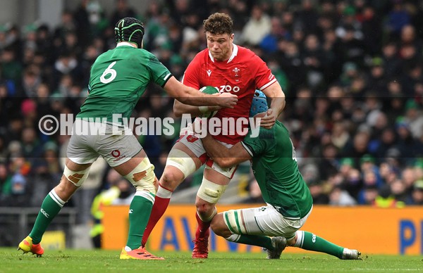 050222 - Ireland v Wales - Guinness Six Nations - Will Rowlands of Wales takes on Caelan Doris and Tadhg Beirne of Ireland