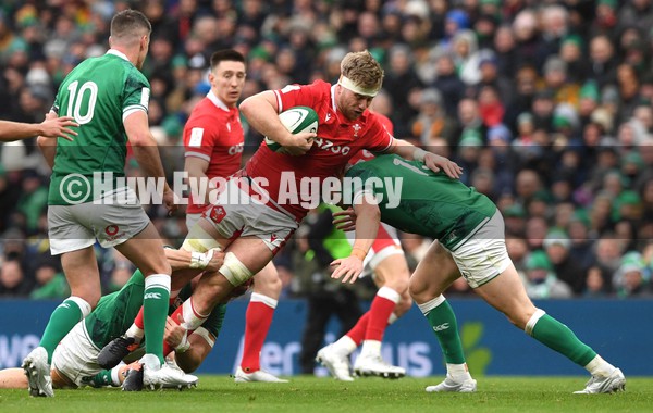 050222 - Ireland v Wales - Guinness Six Nations - Aaron Wainwright of Wales is tackled by Josh van der Flier and Garry Ringrose of Ireland