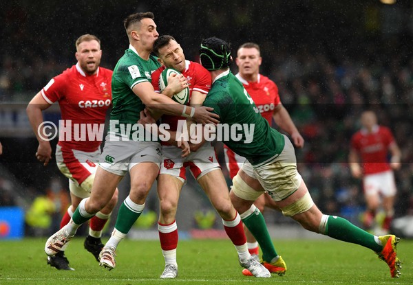 050222 - Ireland v Wales - Guinness Six Nations - Gareth Davies of Wales is tackled by James Hume and James Ryan of Ireland