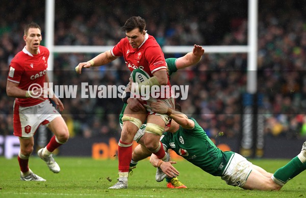 050222 - Ireland v Wales - Guinness Six Nations - Taine Basham of Wales is tackled by Garry Ringrose and James Hume of Ireland