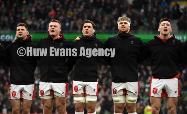 050222 - Ireland v Wales - Guinness Six Nations - Tomos Williams, Dewi Lake, Taine Basham, Aaron Wainwright and Josh Adams of Wales during the anthems