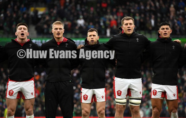 050222 - Ireland v Wales - Guinness Six Nations - Josh Adams, Johnny McNicholl, Gareth Davies, Ben Carter and Louis Rees-Zammit of Wales during the anthems