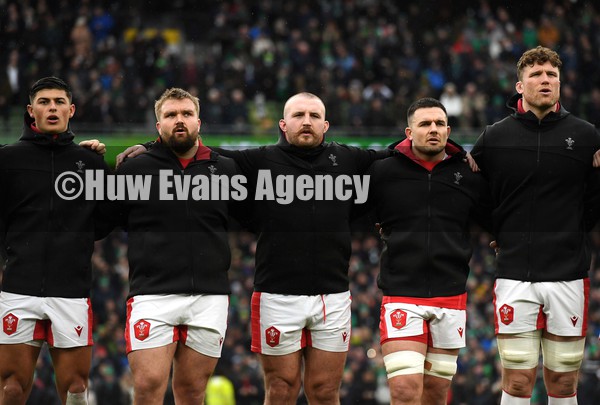 050222 - Ireland v Wales - Guinness Six Nations - Louis Rees-Zammit, Tomas Francis, Dillon Lewis, Ellis Jenkins and Will Rowlands of Wales during the anthems