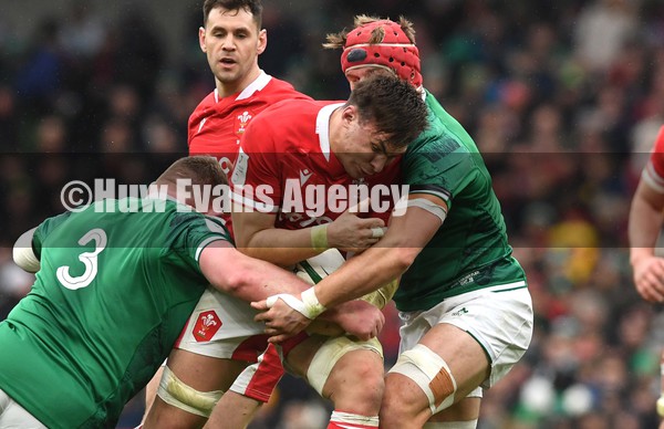 050222 - Ireland v Wales - Guinness Six Nations - Taine Basham of Wales is tackled by Tadhg Furlong and Josh van der Flier of Ireland