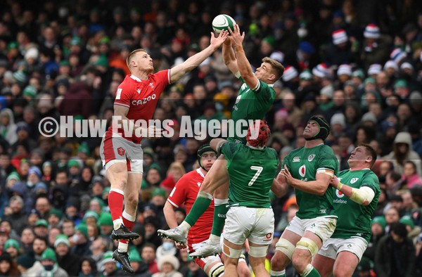 050222 - Ireland v Wales - Guinness Six Nations - Johnny McNicholl of Wales jumps for high ball against Garry Ringrose of Ireland