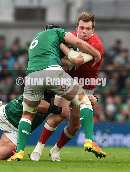 050222 - Ireland v Wales - Guinness Six Nations - Nick Tompkins of Wales is tackled by Caelan Doris and Andrew Porter of Ireland