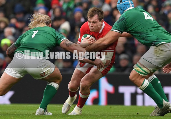 050222 - Ireland v Wales - Guinness Six Nations - Nick Tompkins of Wales is tackled by Andrew Porter and James Ryan of Ireland