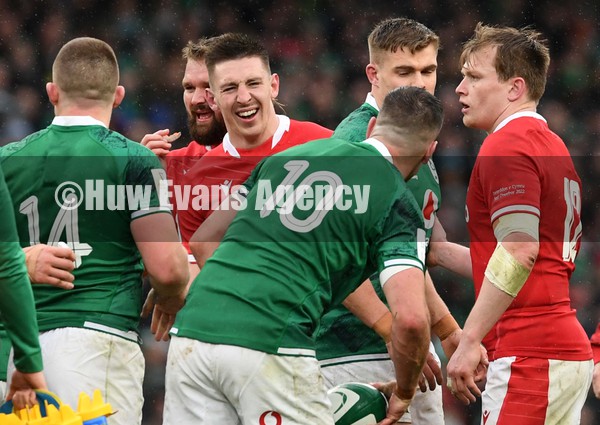 050222 - Ireland v Wales - Guinness Six Nations - Josh Adams of Wales reacts after colliding with Johnny Sexton of Ireland