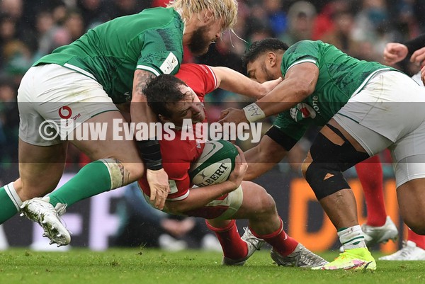 050222 - Ireland v Wales - Guinness Six Nations - Ryan Elias of Wales is tackled by Andrew Porter and Bundee Aki of Ireland