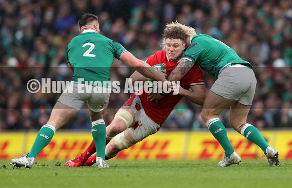 050222 - Ireland v Wales - Guinness Six Nations Championship - Will Rowlands of Wales is tackled by Andrew Porter of Ireland