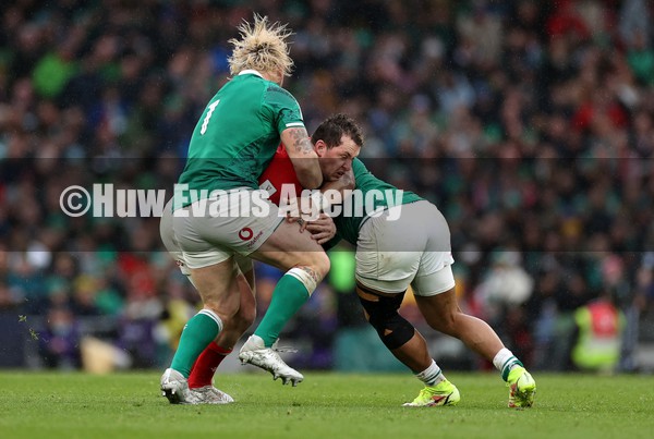 050222 - Ireland v Wales - Guinness Six Nations Championship - Ryan Elias of Wales is tackled by Andrew Porter and Bundee Aki of Ireland