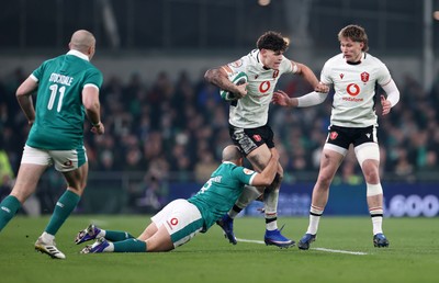 060326 - Ireland v Wales - Guinness Six Nations Championship - Eddie James of Wales is tackled by Jamison Gibson-Park of Ireland 
