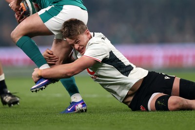 060326 - Ireland v Wales - Guinness Six Nations Championship - Alex Mann of Wales tackles Jamison Gibson-Park of Ireland 
