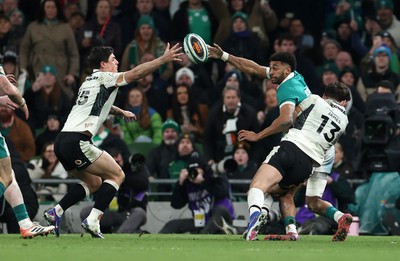 060326 - Ireland v Wales - Guinness Six Nations Championship - Robert Baloucoune of Ireland is challenged by Louis Rees-Zammit of Wales 
