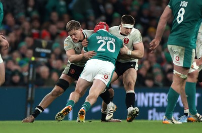 060326 - Ireland v Wales - Guinness Six Nations Championship - Josh van der Flier of Ireland is tackled by Alex Mann and Joe Hawkins of Wales 