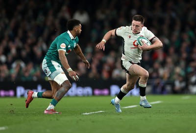 060326 - Ireland v Wales - Guinness Six Nations Championship - Josh Adams of Wales is tackled by Robert Baloucoune of Ireland 