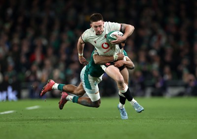 060326 - Ireland v Wales - Guinness Six Nations Championship - Josh Adams of Wales is tackled by Robert Baloucoune of Ireland 