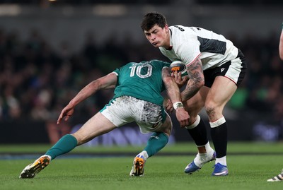 060326 - Ireland v Wales - Guinness Six Nations Championship - Louis Rees-Zammit of Wales is tackled by Jack Crowley of Ireland 