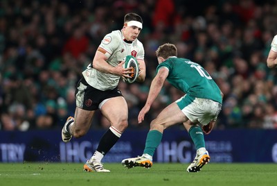 060326 - Ireland v Wales - Guinness Six Nations Championship - Eddie James of Wales is tackled by Jack Crowley of Ireland 