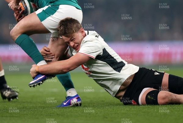 060326 - Ireland v Wales - Guinness Six Nations Championship - Alex Mann of Wales tackles Jamison Gibson-Park of Ireland 
