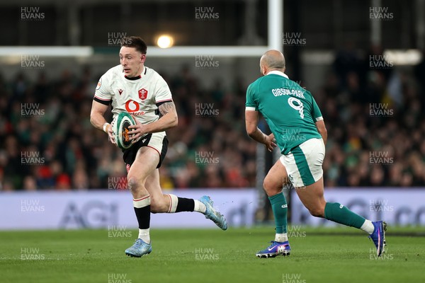 060326 - Ireland v Wales - Guinness Six Nations Championship - Josh Adams of Wales is challenged by Jamison Gibson-Park of Ireland 