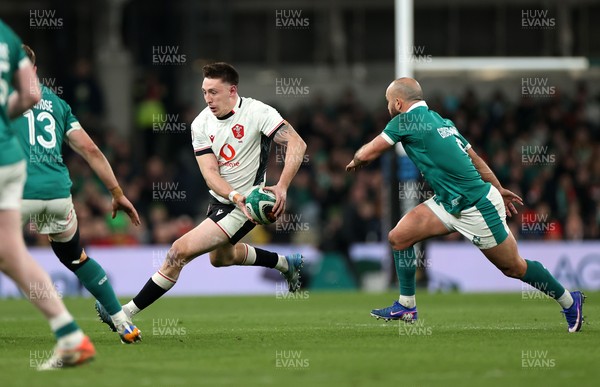060326 - Ireland v Wales - Guinness Six Nations Championship - Josh Adams of Wales is challenged by Jamison Gibson-Park of Ireland 