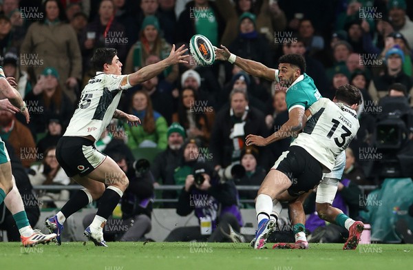 060326 - Ireland v Wales - Guinness Six Nations Championship - Robert Baloucoune of Ireland is challenged by Louis Rees-Zammit of Wales 