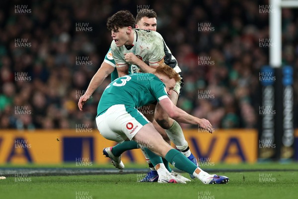 060326 - Ireland v Wales - Guinness Six Nations Championship - Eddie James of Wales is tackled by Ciaran Frawley of Ireland 
