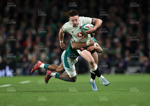 060326 - Ireland v Wales - Guinness Six Nations Championship - Josh Adams of Wales is tackled by Robert Baloucoune of Ireland 