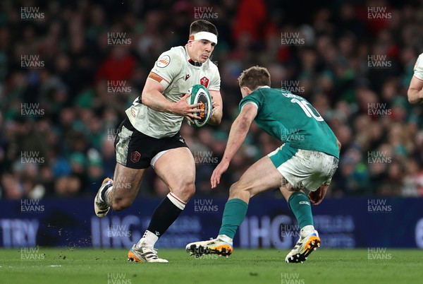 060326 - Ireland v Wales - Guinness Six Nations Championship - Eddie James of Wales is tackled by Jack Crowley of Ireland 