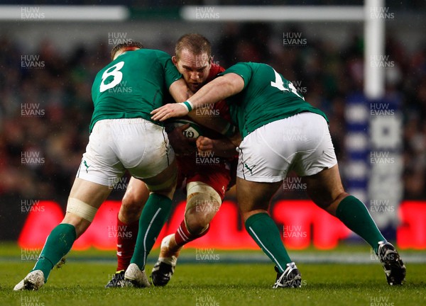 080214 - Ireland v Wales - RBS 6 Nations -  Gethin Jenkins of Wales tackled by Jamie Heaslip and Martin Moore of Ireland(c) Huw Evans Agency