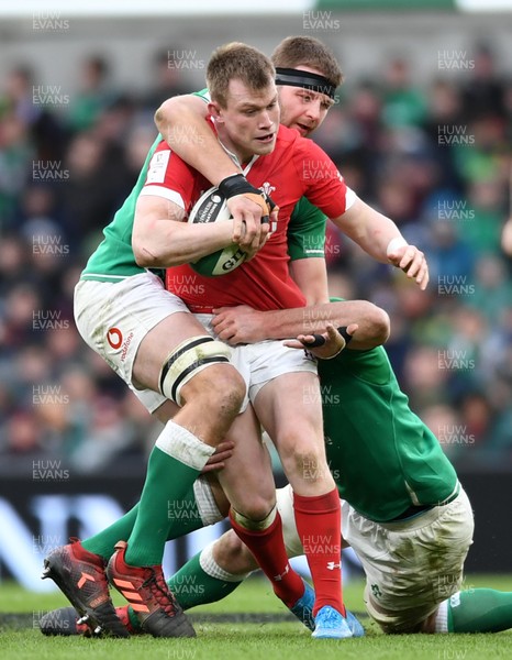 080220 - Ireland v Wales - Guinness Six Nations - Nick Tompkins of Wales is tackled by Iain Henderson and James Ryan of Ireland