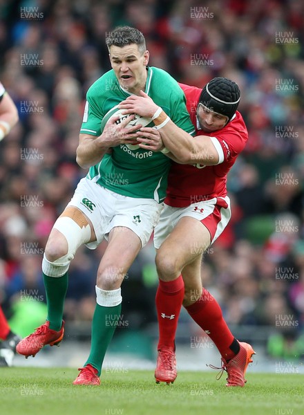 080220 - Ireland v Wales - Guinness 6 Nations - Jonathan Sexton of Ireland is tackled by Leigh Halfpenny of Wales