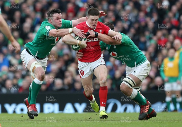 080220 - Ireland v Wales - Guinness 6 Nations - Josh Adams of Wales is tackled by James Ryan and Iain Henderson of Ireland
