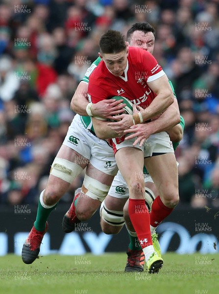 080220 - Ireland v Wales - Guinness 6 Nations - Josh Adams of Wales is tackled by James Ryan and Iain Henderson of Ireland
