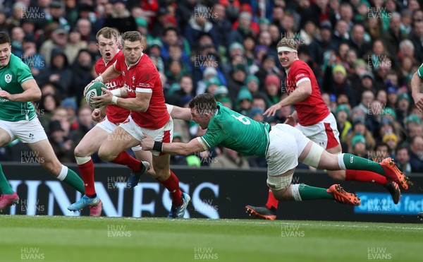 080220 - Ireland v Wales - Guinness 6 Nations - Dan Biggar of Wales is challenged by as he off loads the ball