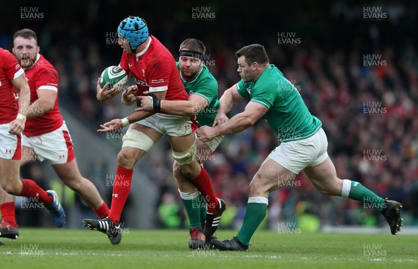 080220 - Ireland v Wales - Guinness 6 Nations - Justin Tipuric of Wales is tackled by Iain Henderson and Cian Healy of Ireland