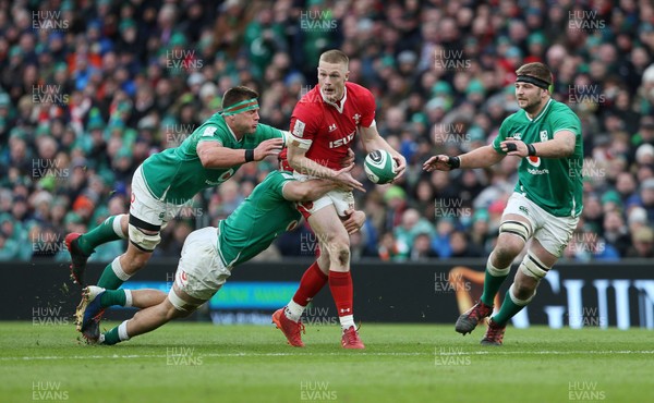 080220 - Ireland v Wales - Guinness 6 Nations - Johnny McNicholl of Wales is tackled by Josh van der Flier and CJ Stander of Ireland