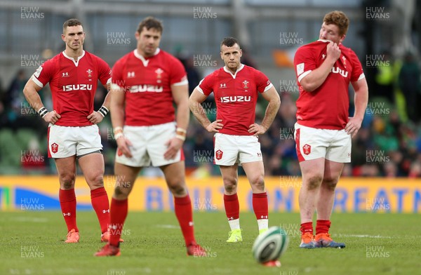 080220 - Ireland v Wales - Guinness 6 Nations - Dejected George North, Gareth Davies and Rhys Carre of Wales look on as Leigh Halfpenny kicks the conversion