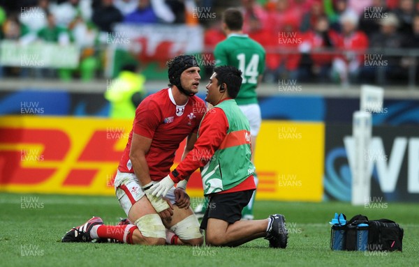 08.10.11 - Ireland v Wales - Rugby World Cup Quarter-Final 2011 - Luke Charteris of Wales is treated by physio Prav Mathema. 