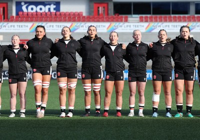 090526 - Ireland v Wales, 2026 Guinness Women’s 6 Nations - Left to right, Seren Lockwood of Wales, Jorja Aiono of Wales,Branwen Metcalfe of Wales, Bryonie King of Wales, Molly Reardon of Wales, Nikita Prothero of Wales, Freya Bell of Wales and Maisie Davies of Wales line up for the anthems ahead of the match