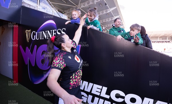 090526 - Ireland v Wales, 2026 Guinness Women’s 6 Nations - Branwen Metcalfe of Wales high fives a young fan ahead of the match