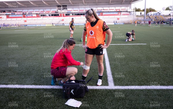 090526 - Ireland v Wales, 2026 Guinness Women’s 6 Nations - Georgina Ewer adjusts strapping for Freya Bell of Wales