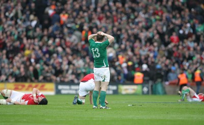 13.03.10 Ireland v Wales... Ireland's Brian O'Driscoll victorious at the final whistle as Welsh players lie on the ground. 