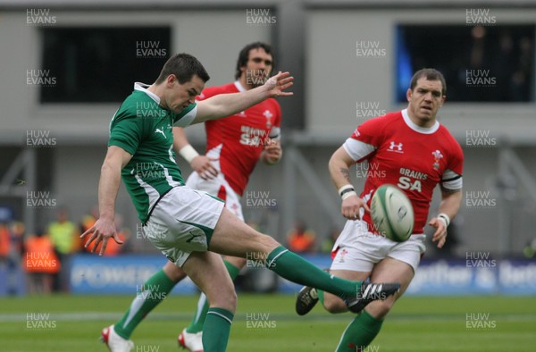 13.03.10 Ireland v Wales... Ireland's Jonathan Sexton kicks in front of Paul James. 
