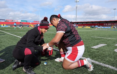 130424 - Ireland  v Wales, Guinness Women’s 6 Nations - Sisilia Tuipulotu of Wales has her wrists strapped ahead of the match by Cara Jones, physio