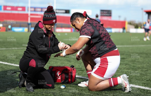130424 - Ireland  v Wales, Guinness Women’s 6 Nations - Sisilia Tuipulotu of Wales gets her wrist strapped by Cara Jones, physio ahead of the match