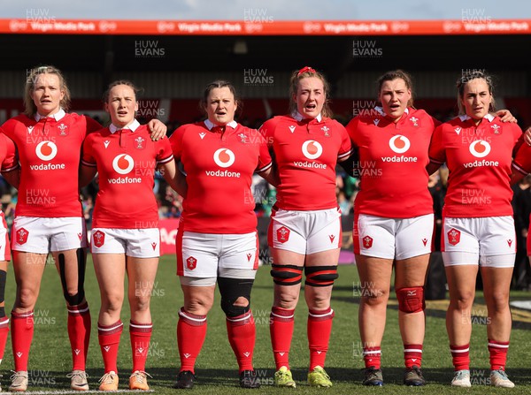 130424 - Ireland  v Wales, Guinness Women’s 6 Nations - Left to right, Wales’ Carys Cox, Jenny Hesketh, Abbey Constable, Abbie Fleming, Gwenllian Pyrs and Courtney Keight during the anthem