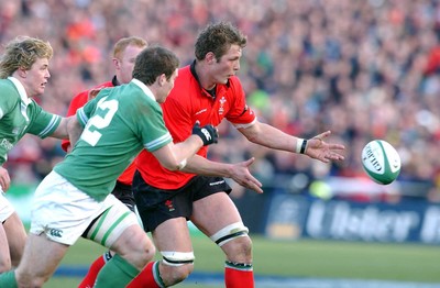 22.02.04  Ireland v Wales  Wales Dafydd Jones releases as Brian O'Driscoll and Gordon D'Arcy close in.  Huw Evans,Cardiff